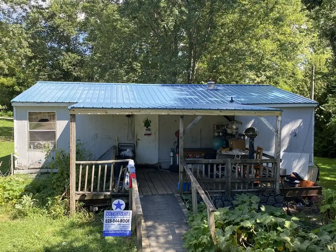Blue standing-seam metal roof installed by Southern Star Roofing in the Asheville NC area